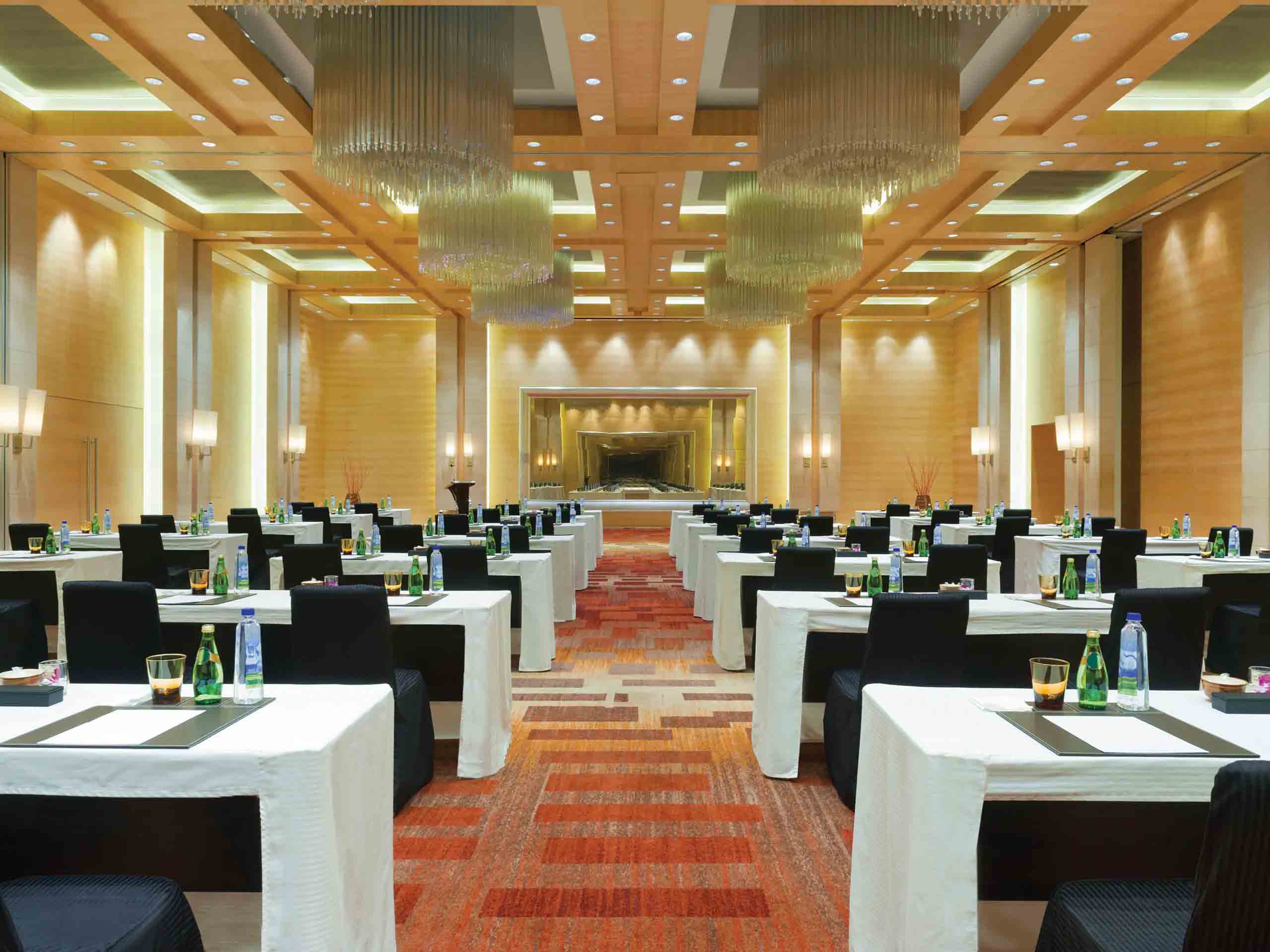 Side-by-side comparison of affordable and luxury conference planning in Chennai, showing a simple boardroom and an elegant banquet hall