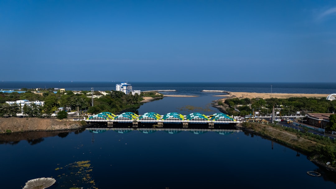 Aerial view of a beach resort wedding setup in Chennai with 500 guests seated under mandap lights at sunset