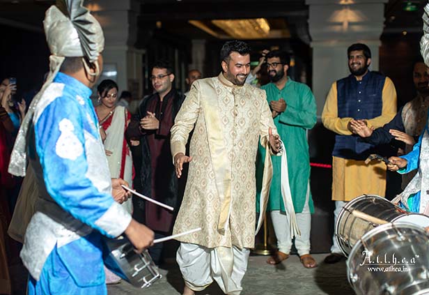 Groom arriving with traditional drum procession during Bengali wedding ceremony