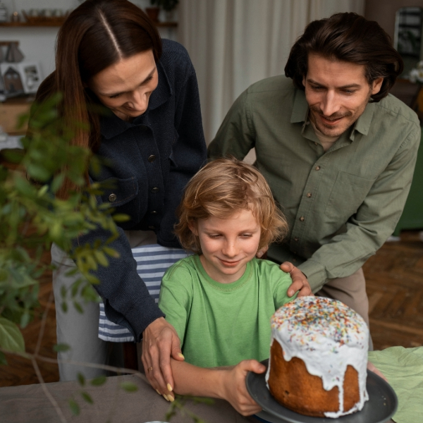 Family gathered around table planning birthday party with notebooks and decorations