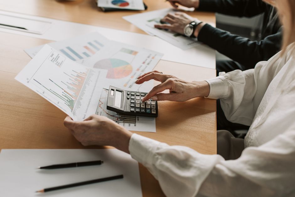 Business meeting budget breakdown Chennai planning workspace with calculator and cost sheets