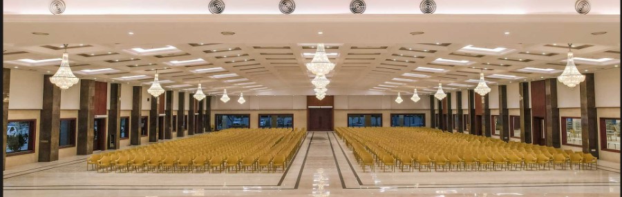 Grand convention centre decorated for a 1000-guest wedding in Chennai with floral arrangements and stage setup