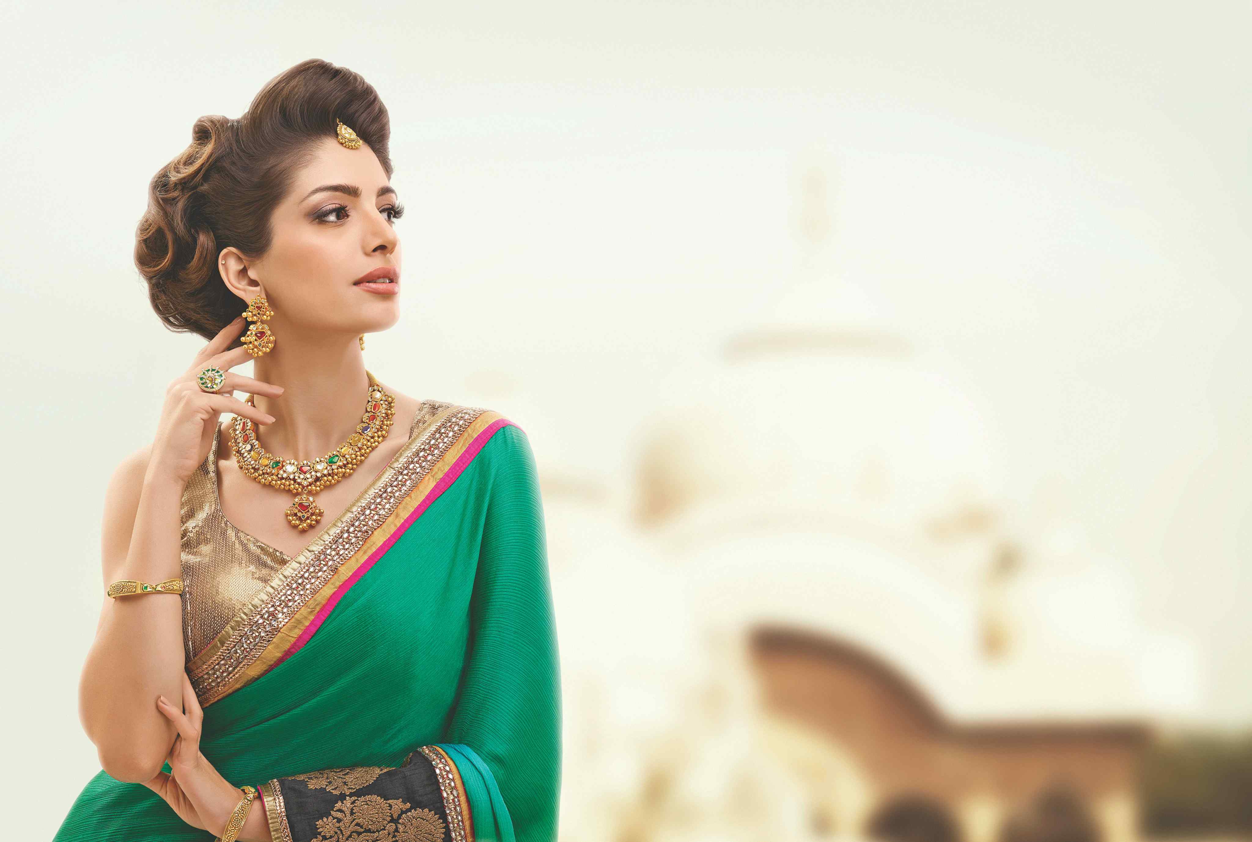 Premium designer saree collections displayed in elegant boutique setting with price tags and styling options