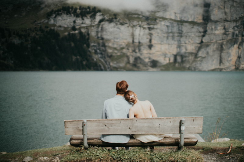 Beautiful couple posing for destination photoshoot at scenic location with photographer