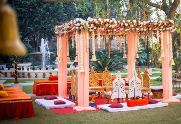 Elegant event decoration setup with floral arrangements, lighting, and table settings for celebration