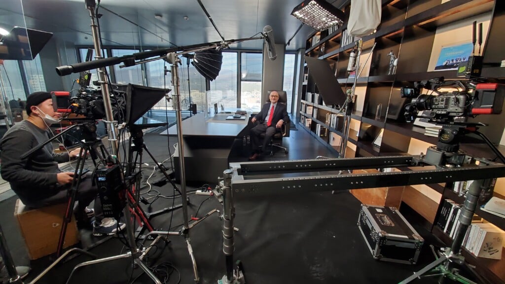 Professional video crew filming a wedding ceremony with modern equipment