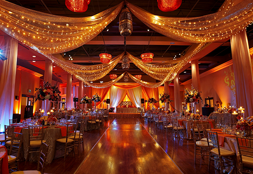 Multiple themed activity zones at an Indian wedding venue with different entertainment options