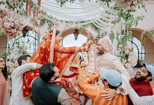 Traditional Indian wedding games with guests sitting in circles playing antakshari