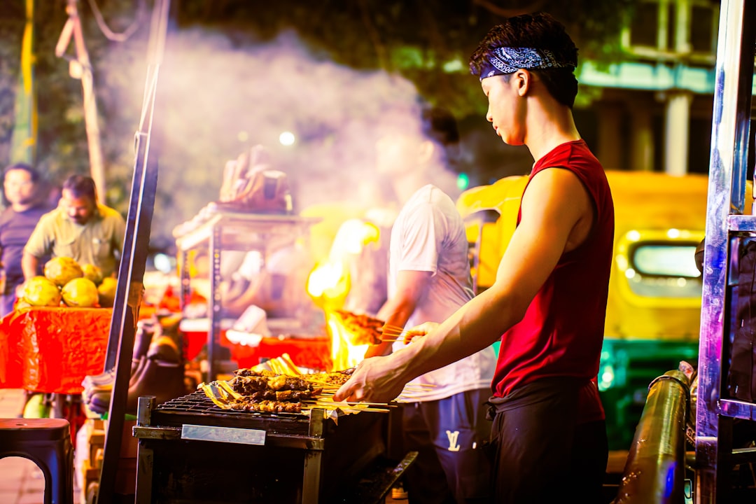 Live BBQ counters at an Indian wedding celebration with professional chefs grilling meat and vegetables for guests