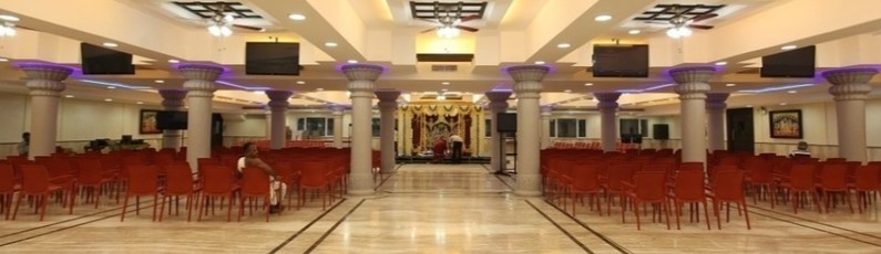 Elegant marriage hall decorated for 750 guests in Chennai with floral mandap and banquet seating