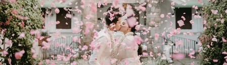 Petal Shower Chennai — bride and groom standing under a cascade of rose petals at a Chennai wedding reception