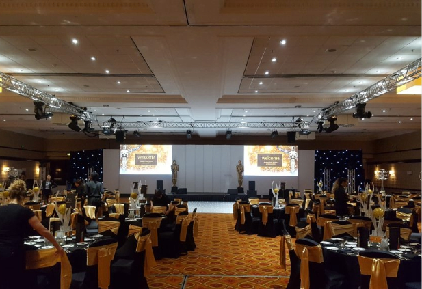 Elegant seminar stage decor Chennai with floral backdrop, branded podium and ambient lighting at a professional conference venue
