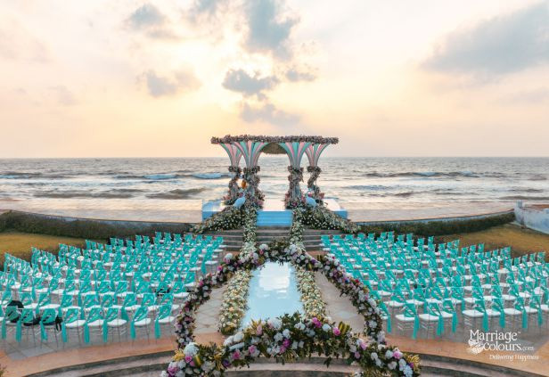 Luxurious beachfront Indian wedding mandap and teal guest seating at a venue in Chennai.