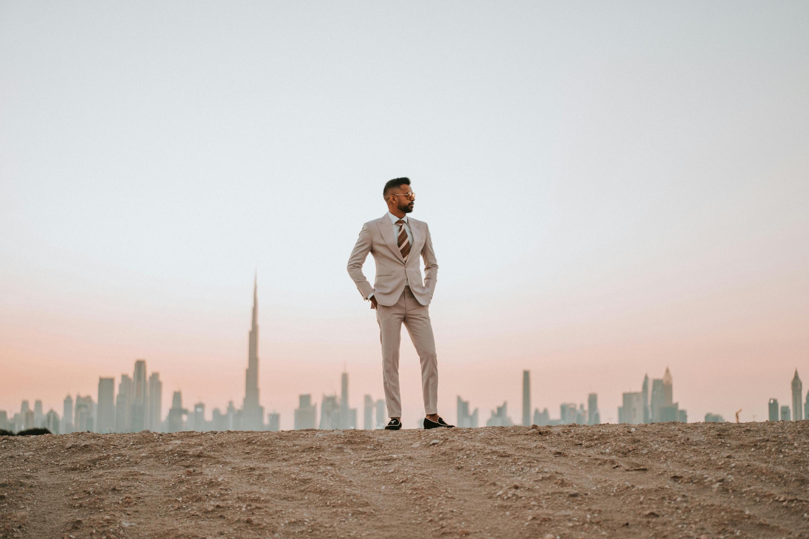 Split image showing traditional Indian groom in sherwani and modern groom in suit