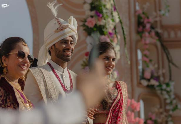 Groom smiling during varmala ceremony moment at wedding stage