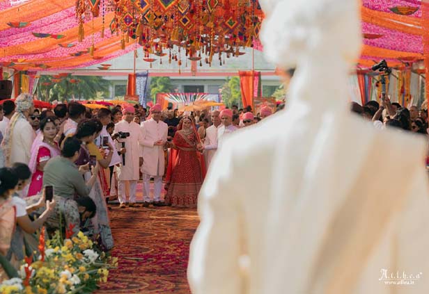 Traditional Indian varmala ceremony under colorful wedding canopy
