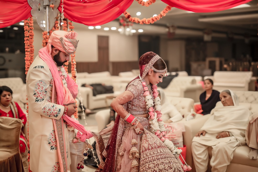 Couples reviewing a venue booking checklist before paying advance for wedding venue