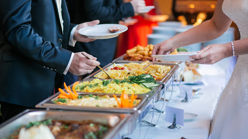Elegant Indian wedding catering setup with various dishes and decorative elements