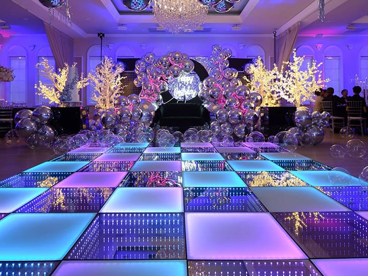 Elegant wedding dance floor Chennai setup with LED lighting and floral decor at a banquet hall