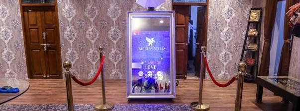 Decorated wedding photo booth Chennai setup with floral backdrop and couple posing