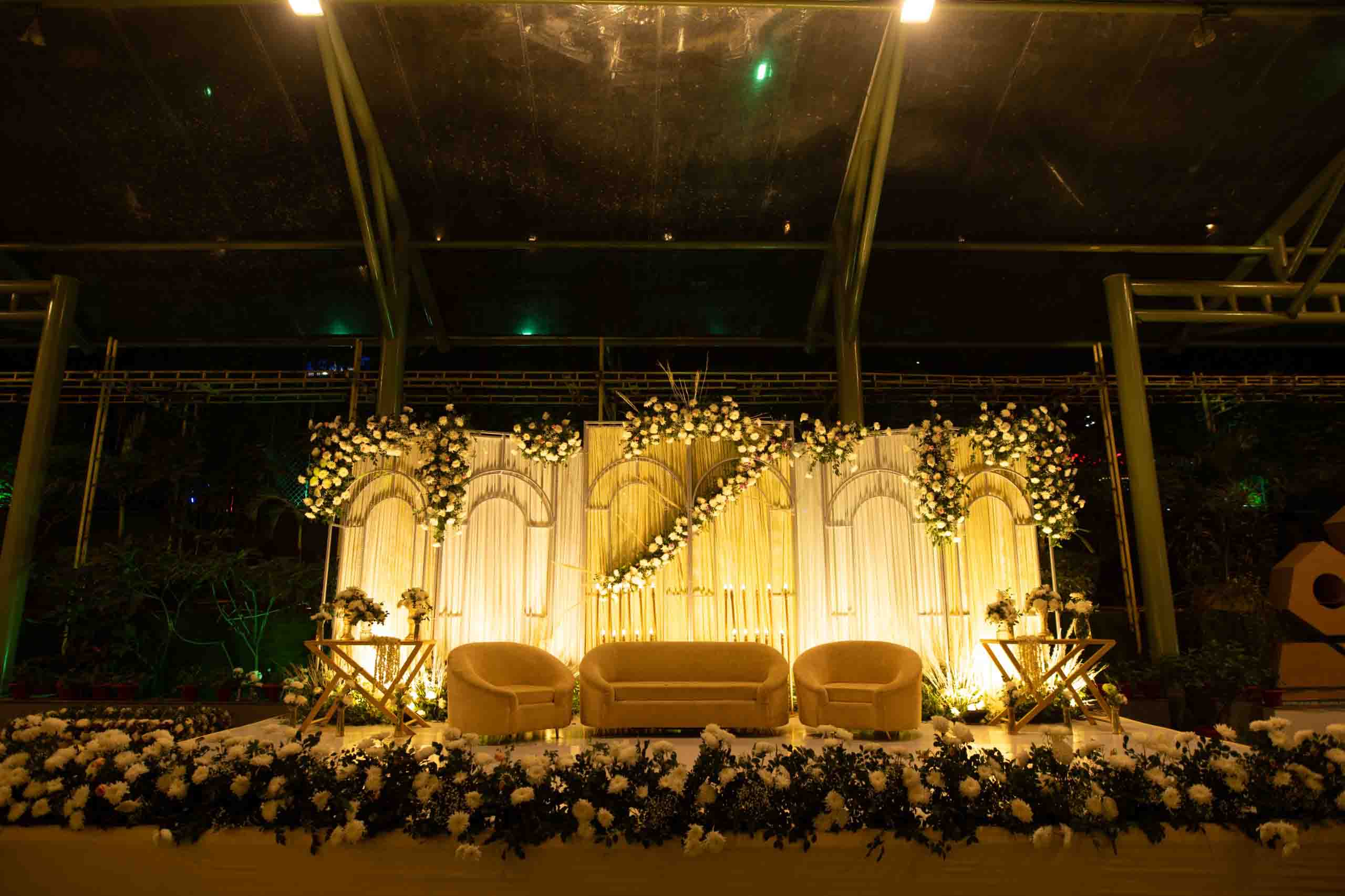 Elegant wedding stage rental Chennai setup with floral arch and LED backdrop at a banquet hall
